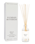 Hello Fall clear glass reed diffuser with reeds beside its Sweet Water Decor packaging