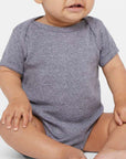 Smiling baby wearing a gray Rabbit Skins 4400 Infant Baby Rib Bodysuit and matching beanie, seated on a light background, showcasing the soft cotton fabric and comfortable fit.