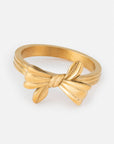 Gold-tone Ribbon Bow Ring with a sculpted bow and ribbon details along the band.