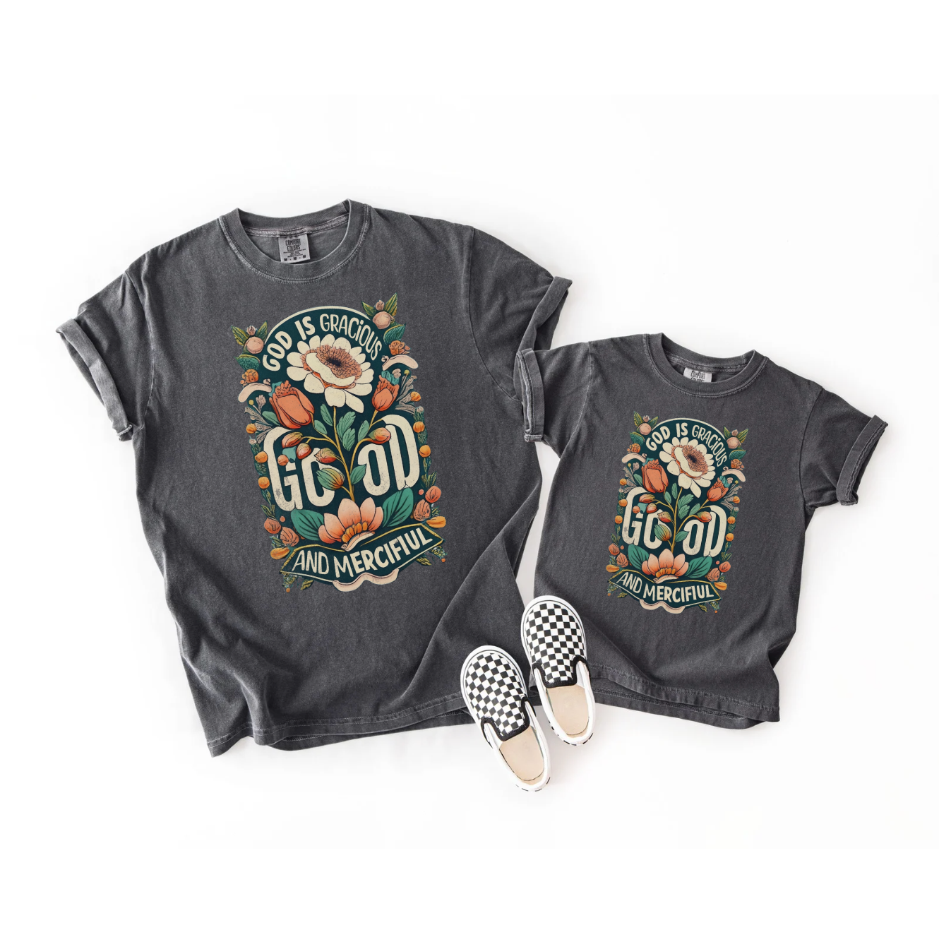 Two dark gray t-shirts with floral design and text, paired with checkered shoes on a white background.