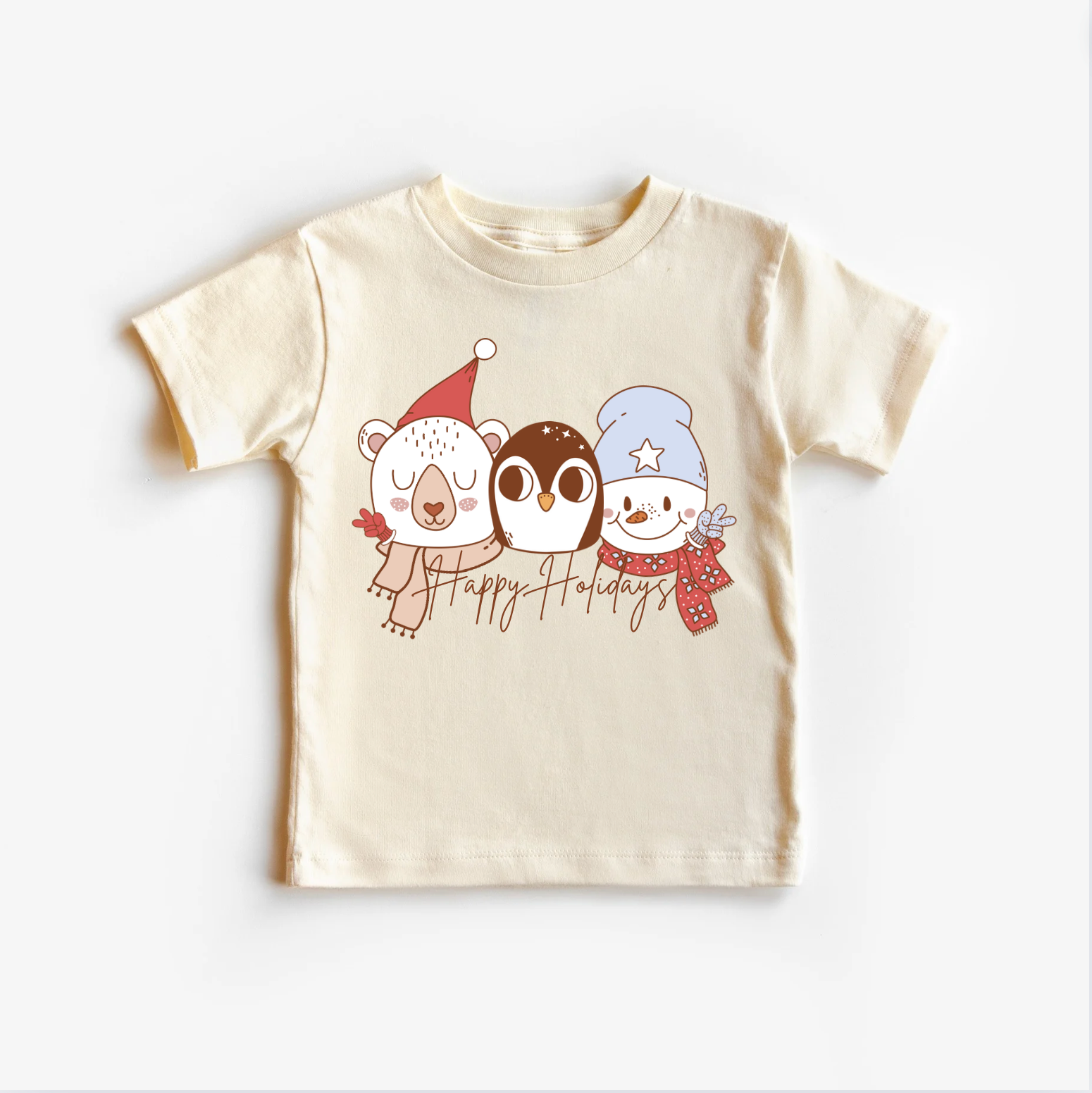 Neutral beige colored t-shirt top with a Christmas themed graphic that includes a bear, a rabbit, and a bird wearing holiday sweaters.