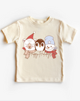 Neutral beige colored t-shirt top with a Christmas themed graphic that includes a bear, a rabbit, and a bird wearing holiday sweaters.