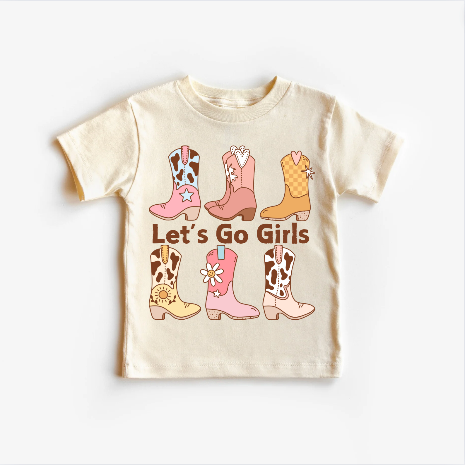 A light-colored children's t-shirt top with illustrations of girls' boots and the text 'LET'S GO GIRLS' printed on it.