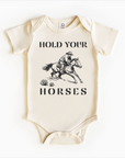 Gender neutral baby bodysuit with “Hold Your Horses” text – available in Bella + Canvas, Colored Organics, and Rabbit Skins