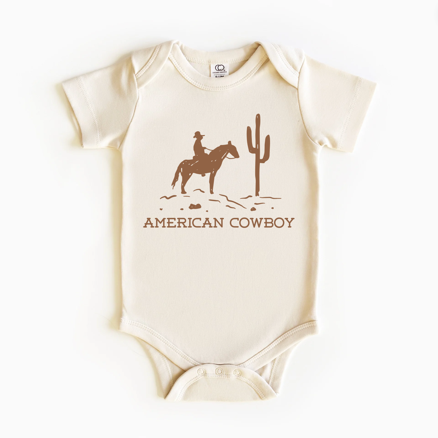 A beige bodysuit with an American cowboy theme, featuring a horse and cactus design, on a short-sleeved pattern.