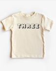 “Three” 3rd Birthday Tee – Neutral Toddler T-Shirt (Multiple Fits & Styles)