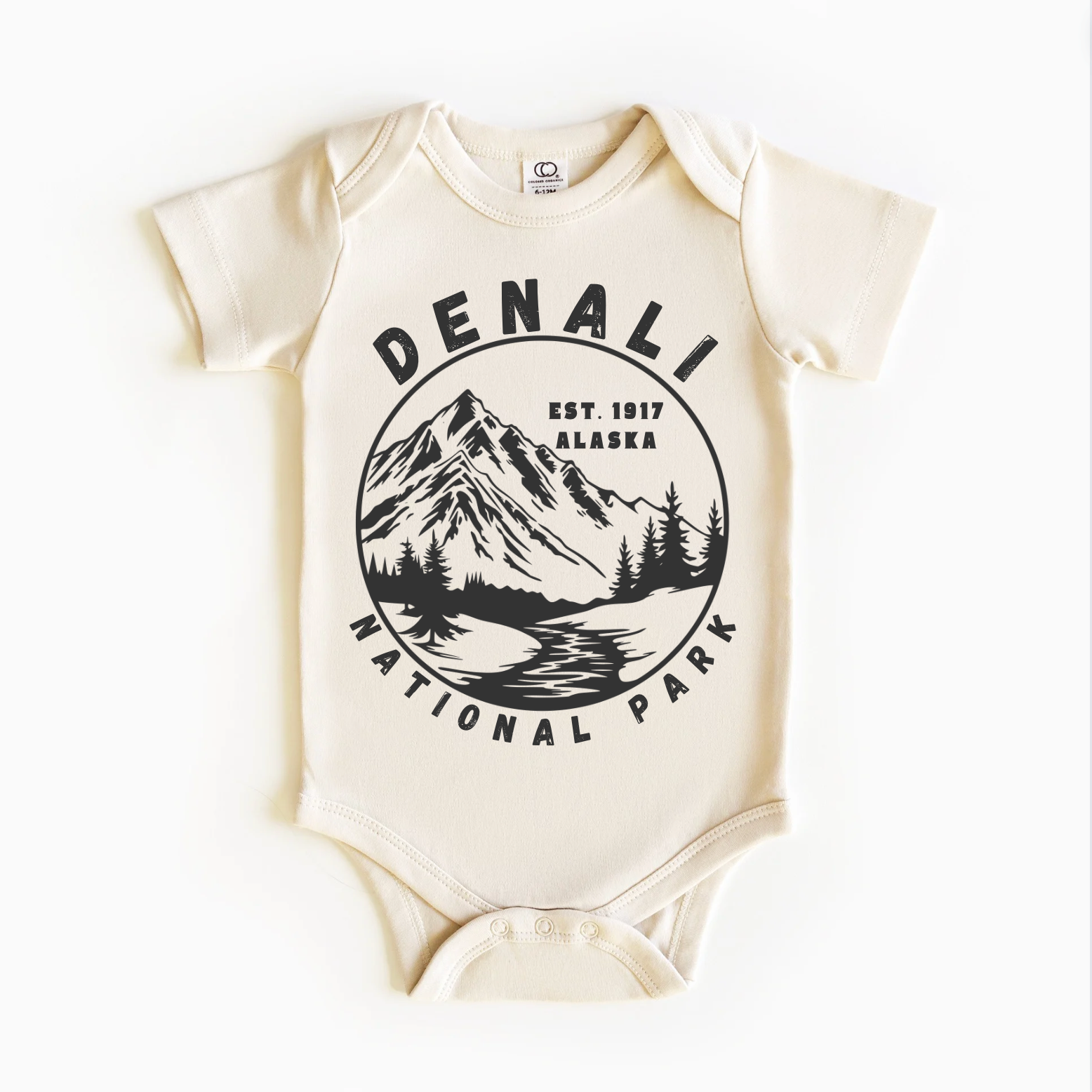 A beige bodysuit with a black and white print of Denali National Park, Alaska on the front.
