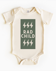 A gender-neutral baby bodysuit onesie in a beige color with a green text that reads 'RAD CHILD' and five green lightning bolts graphic.