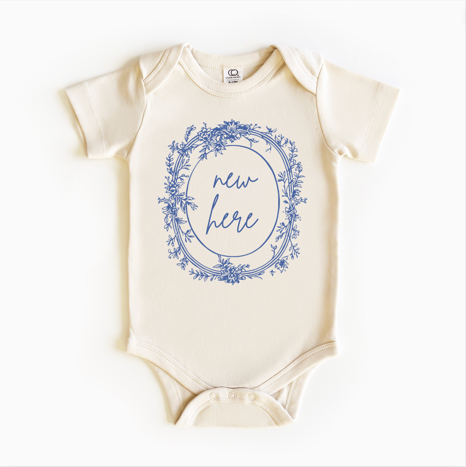 A white bodysuit onesie with blue floral pattern and the text 'new here' printed in the center.