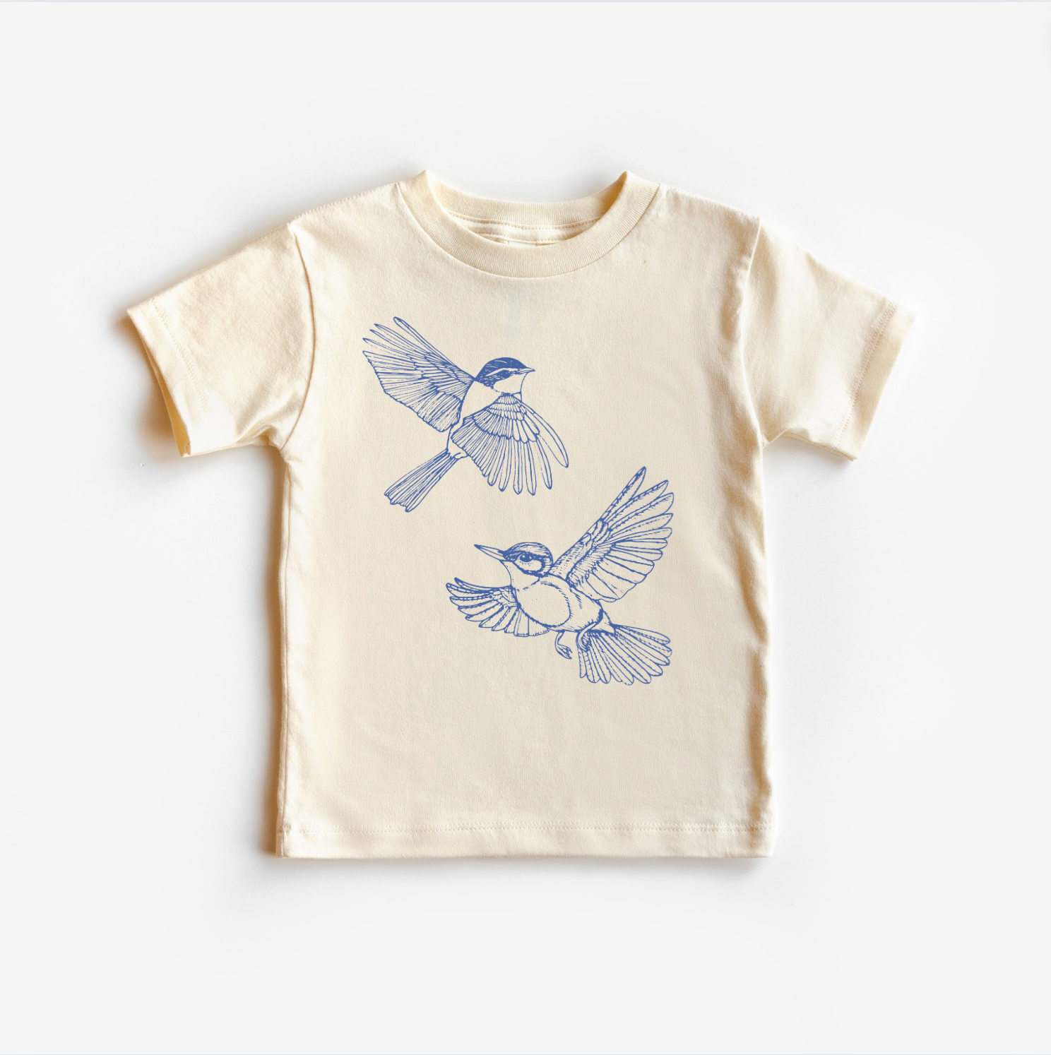 A light-colored, unisex gender neutral tee shirt top with a blue bird design on it, displayed on a white background.