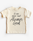 A beige unisex gender neutral tee shirt top with the text 'It was never luck always God' printed on the front.