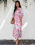 Full-length view of the floral puff sleeve midi dress showing its defined waist and flowing tiered skirt.