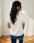 Back view of the white Logan flutter sleeve top styled with jeans