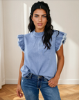 Model wearing the solid blue Logan Flutter Sleeve Denim Top with jeans