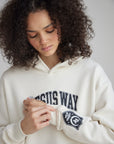 Close-up of The Jesus Way chest lettering and sleeve graphic on the White Down Hoodie