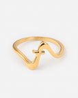 Gold-tone Wavy Cross Ring with a flowing wave-shaped band and small cross detail on a white background