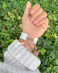 Underside of the Cloud White WWJD bracelet showing its adjustable multicolored braided tie