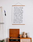 White-background Psalm 23 wall art with dark script lettering displayed above a wooden cabinet.