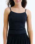 Woman wearing a black dress against a white background