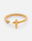 Gold-tone Wrapped Cross Gem Ring with an open band, polished cross, and single clear stone accent
