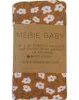 Mebie Baby swaddle with floral pattern on a brown label