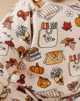 Baby wearing a long-sleeve shirt with autumn-themed pattern