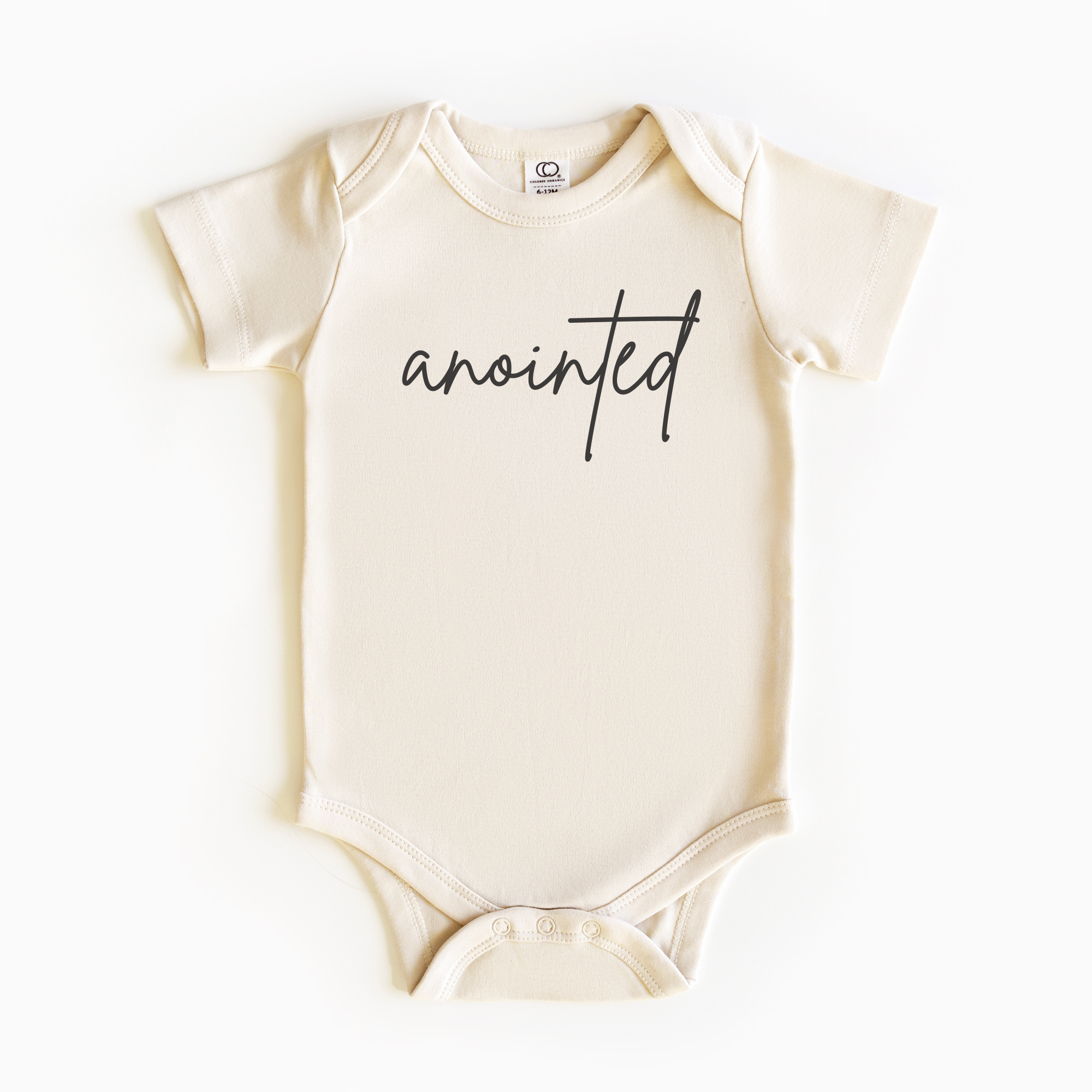 Baby wearing “Anointed” affirmation bodysuit – Christian script design organic cotton outfit by Lumiere Vive