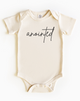 Baby wearing “Anointed” affirmation bodysuit – Christian script design organic cotton outfit by Lumiere Vive