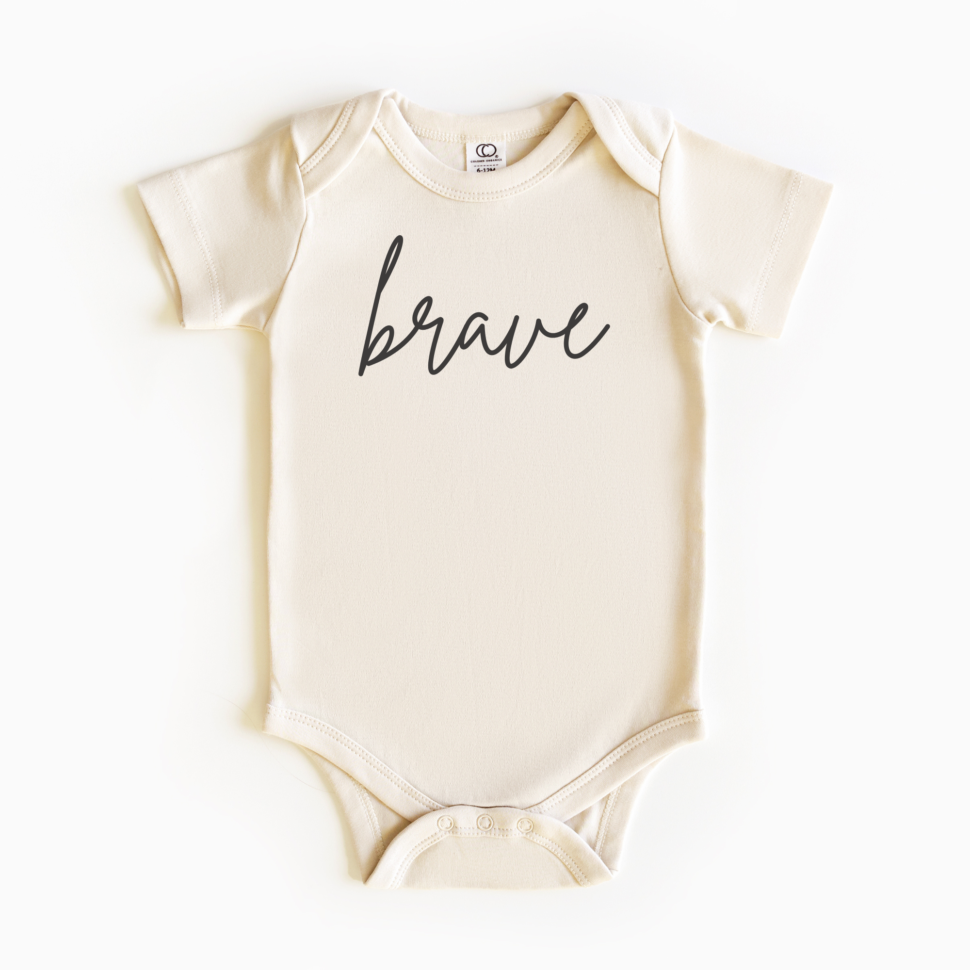 Baby wearing “Brave” affirmation bodysuit – Christian script design organic cotton outfit by Lumiere Vive