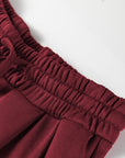 Close-up of the burgundy Sportie sweatpants showing the gathered elastic waistband.