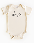 Baby wearing “Chosen” affirmation bodysuit – Christian script design organic cotton outfit by Lumiere Vive