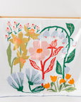 Floral-patterned blanket on a wooden crib with a white background