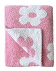 Pink and white floral-patterned towel on a white background