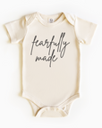 Baby wearing “Fearfully Made” affirmation bodysuit – Christian script design organic cotton outfit by Lumiere Vive