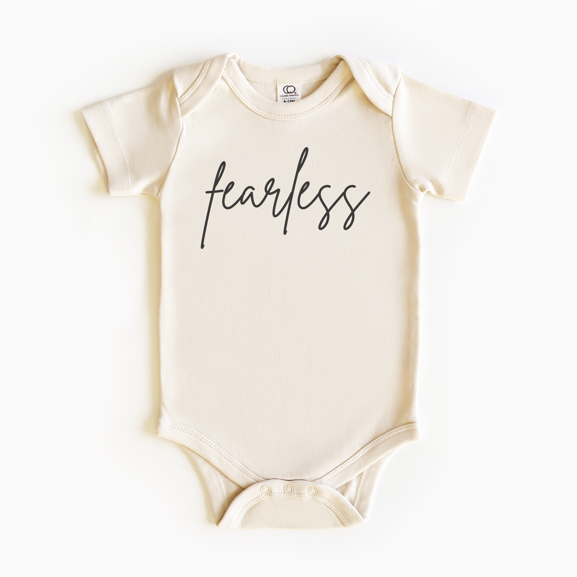 Baby wearing “Fearless” affirmation bodysuit – Christian script design organic cotton outfit by Lumiere Vive