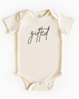 Baby wearing “Gifted” affirmation bodysuit – Christian script design organic cotton outfit by Lumiere Vive