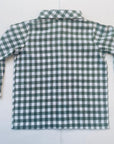Back view of a boys’ green and white gingham collared shirt on a light background.