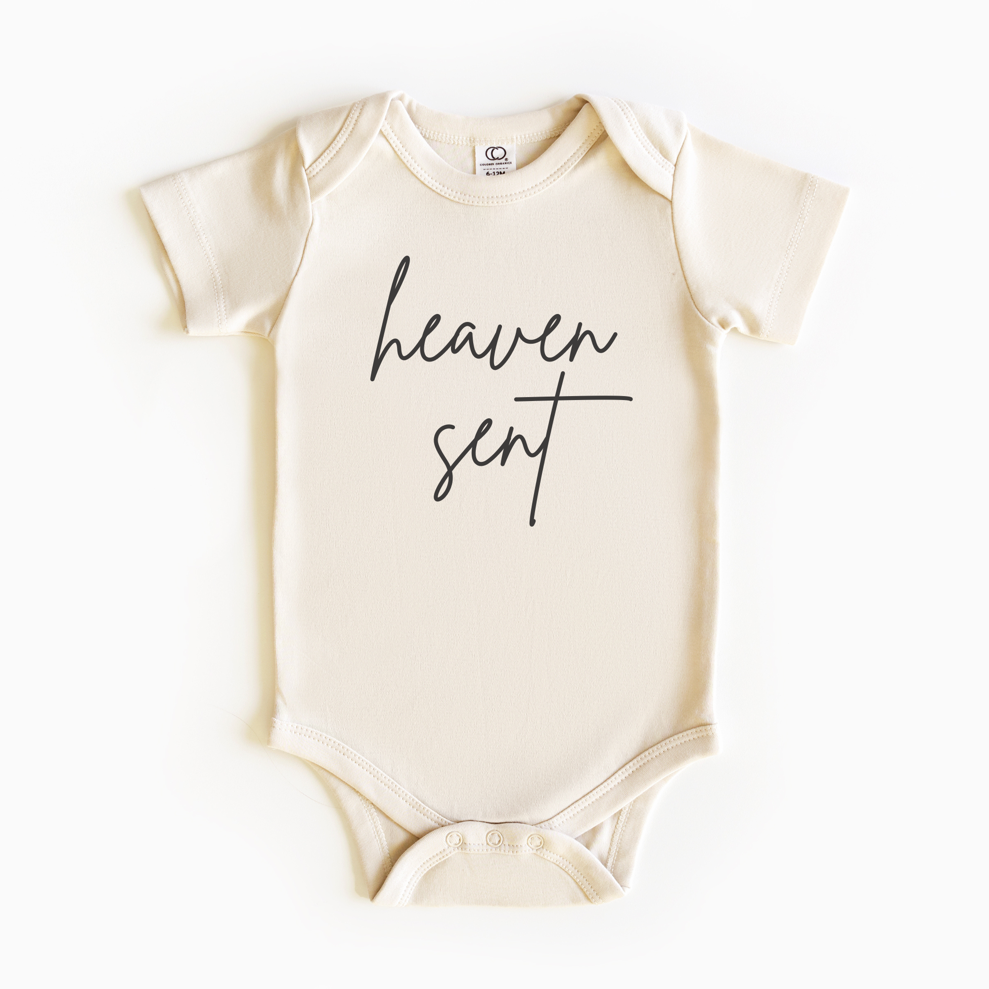 Baby wearing “Heaven Sent” affirmation bodysuit – Christian script design organic cotton outfit by Lumiere Vive