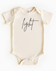 Baby wearing “Light” affirmation bodysuit – Christian script design organic cotton outfit by Lumiere Vive