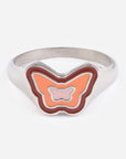 Butterfly-shaped ring with orange and pink design on a white background