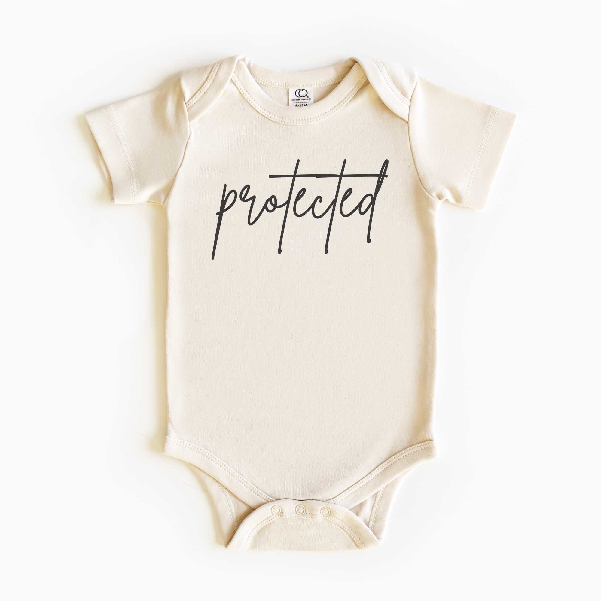 Baby wearing “Protected” affirmation bodysuit – Christian script design organic cotton outfit by Lumiere Vive