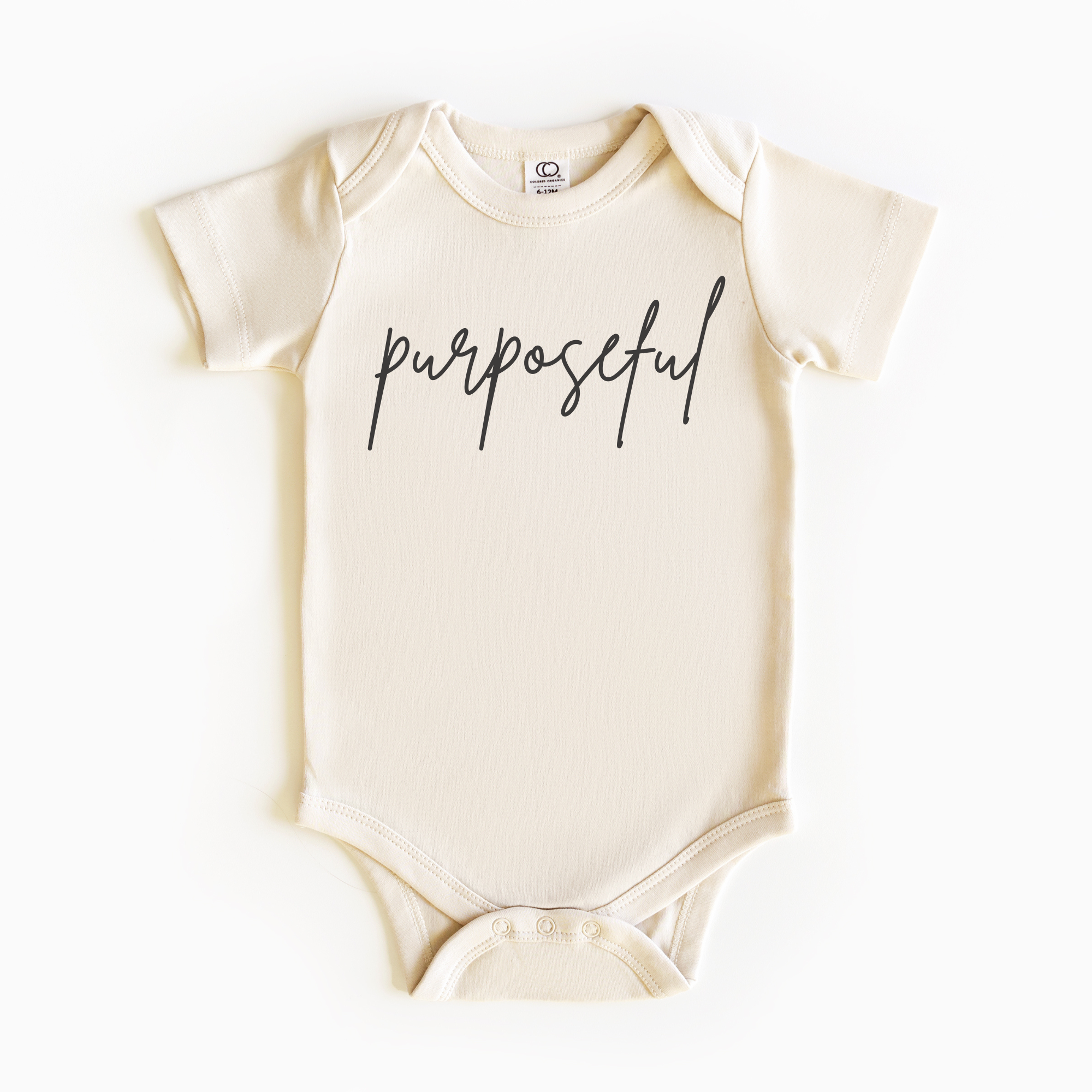 Baby wearing “Purposeful” affirmation bodysuit – Christian script design organic cotton outfit by Lumiere Vive