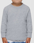 Toddler boy wearing a heather Rabbit Skins 3311 cotton jersey long sleeve tee, front view, ideal for custom printing
