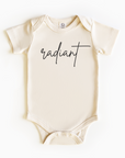 Baby wearing “Radiant” affirmation bodysuit – Christian script design organic cotton outfit by Lumiere Vive