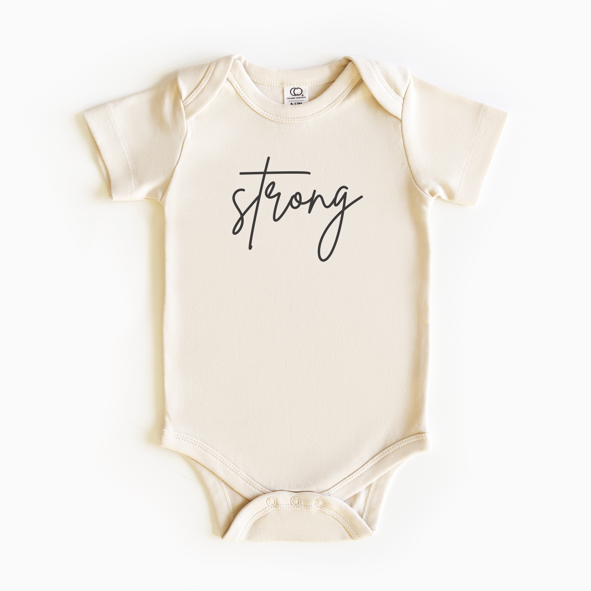 Baby wearing “Strong” affirmation bodysuit – Christian script design organic cotton outfit by Lumiere Vive