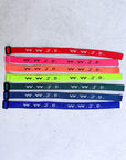 Classic WWJD woven bracelets arranged in a selection of bright and dark colors