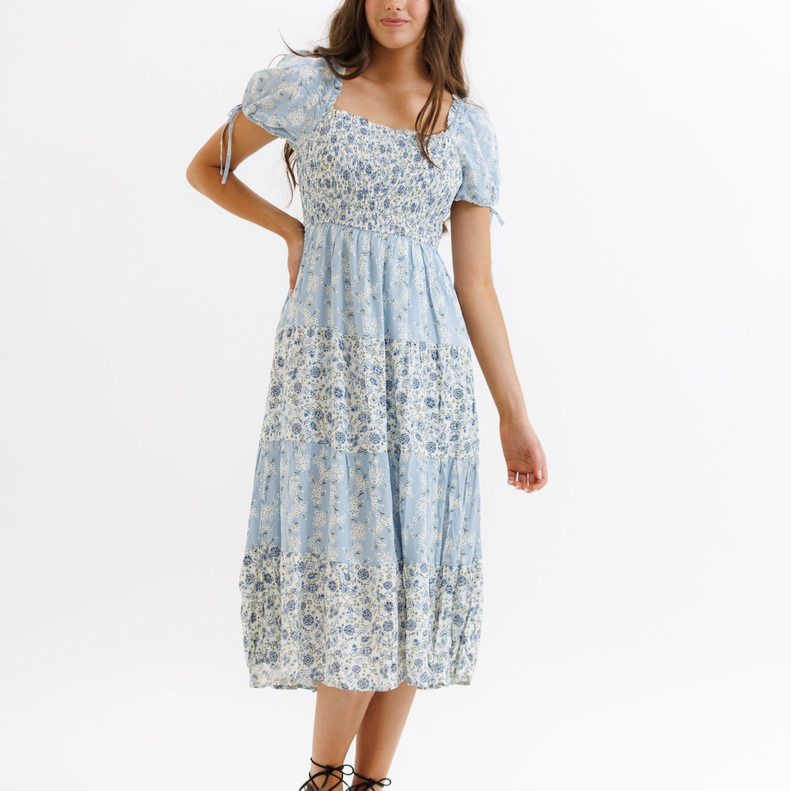Woman wearing a floral dress on a white background