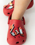 Red children's shoes with cartoon character designs on a white background