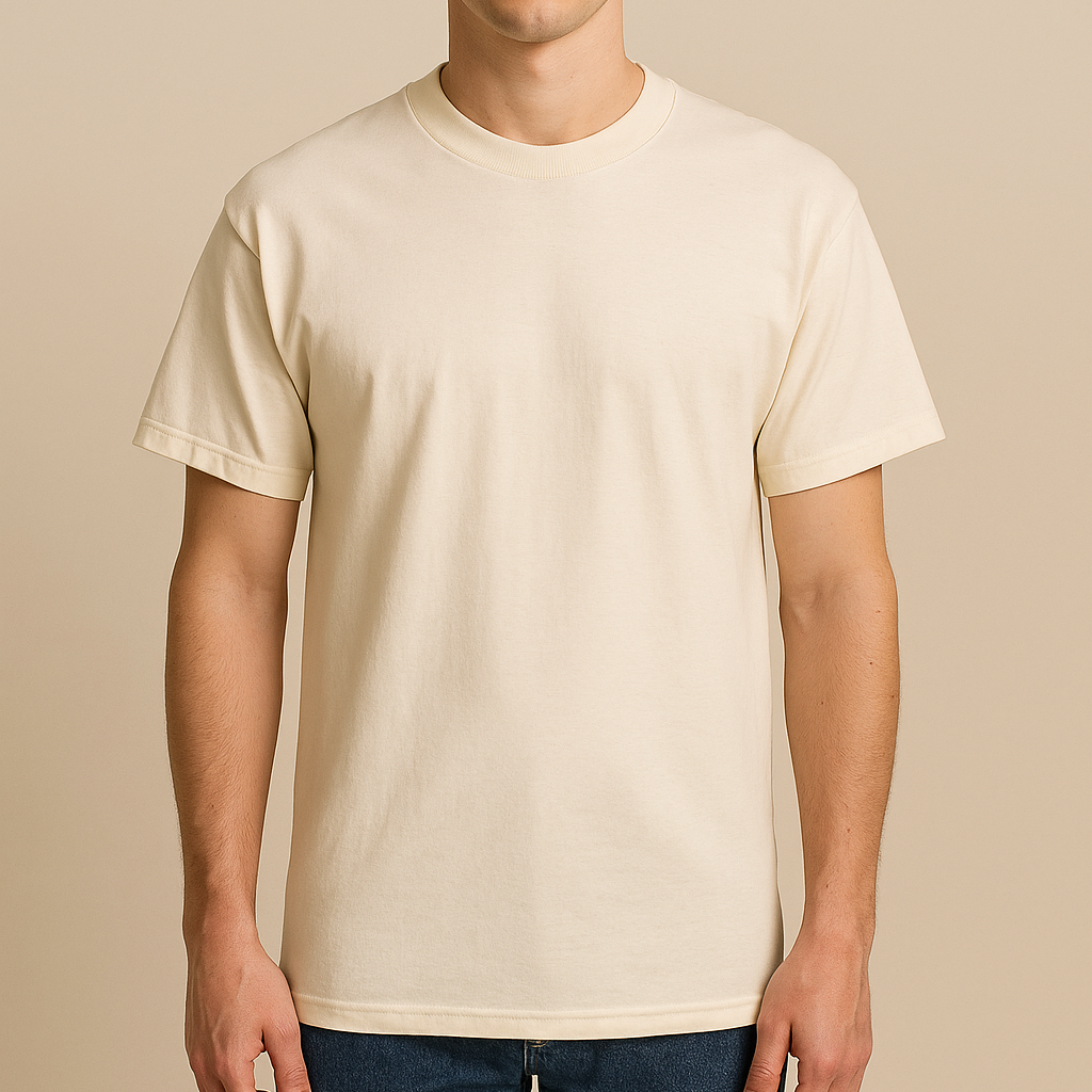Male model wearing a neutral American Apparel 1301 Heavyweight Cotton T-Shirt, photographed in a warm beige studio — unisex blank ideal for custom printing by Lumiere Vive.