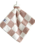 Checkered towel with pink and white pattern on a white background